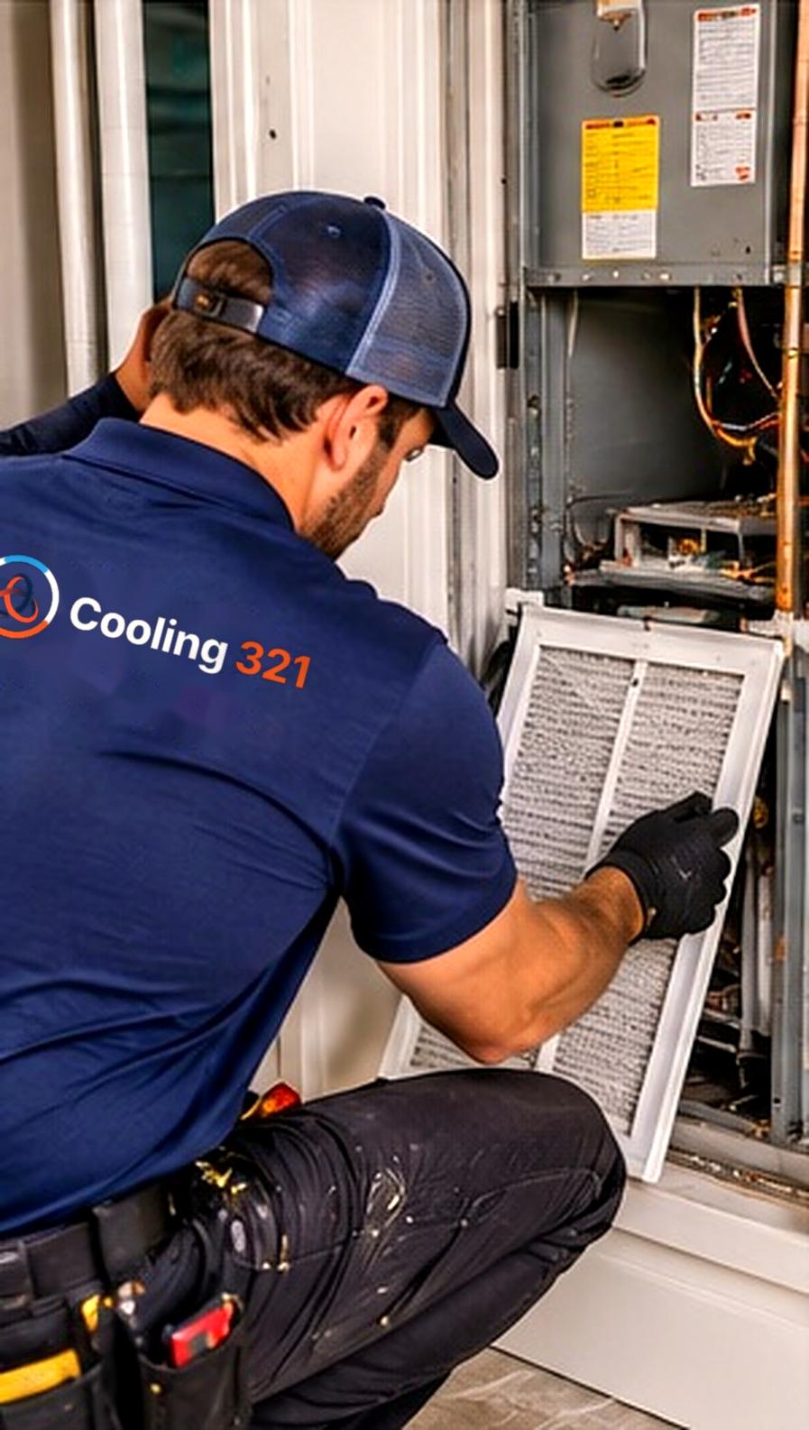 An HVAC technician replacing an air filter (stock photo)